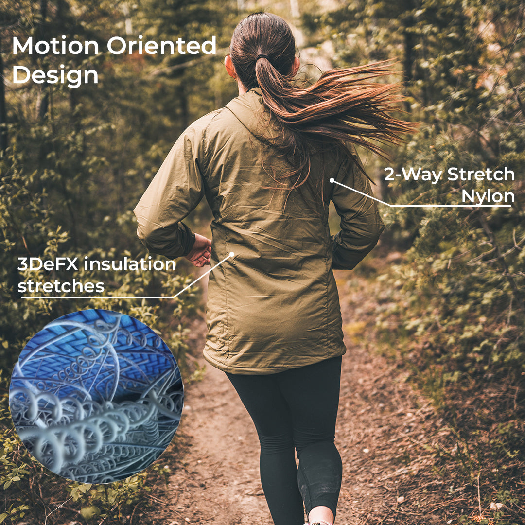 A woman running on a forest path wearing an olive green hooded jacket, with callout text highlighting motion-optimized design, 2-way stretch nylon, and 3DeFX insulation stretches. A circular inset shows the blue and gray elastic fabric detail.