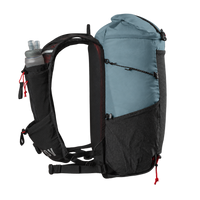 A technical hiking backpack shown from the side on a white background, featuring a light blue top roll-top compartment, black and dark gray body panels, a side water bottle pocket with a bottle inserted, and red drawcord accents.