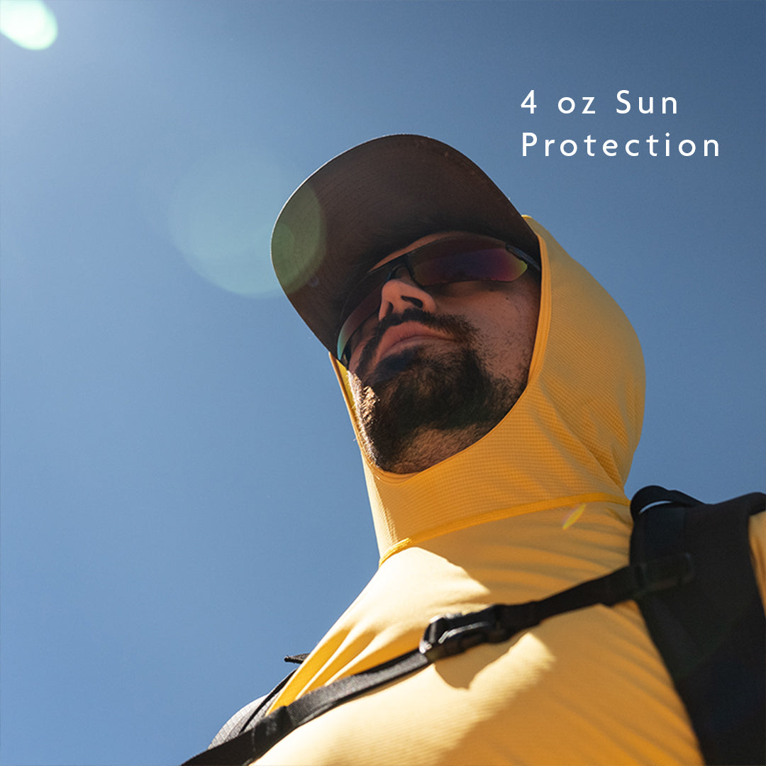 all-groups - Man wearing a yellow sun hoodie against a blue sky