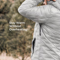 A close-up of a person wearing a light gray puffer jacket outdoors, with the text 'Stay Warm Without Overheating' overlaid on the left side.