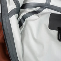 close view of seam taping inside men's ultralight rain jacket for backpacking